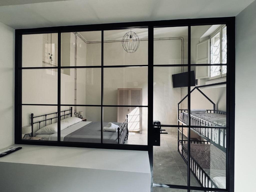 a room with a glass wall with a bed and a staircase at Loft Pisacane 27 - Mare e Centro a Piedi in Senigallia