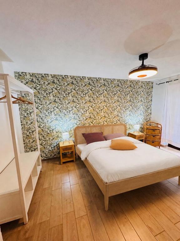 a bedroom with a bed and a floral wall at Casa Lulù in Cala Gonone