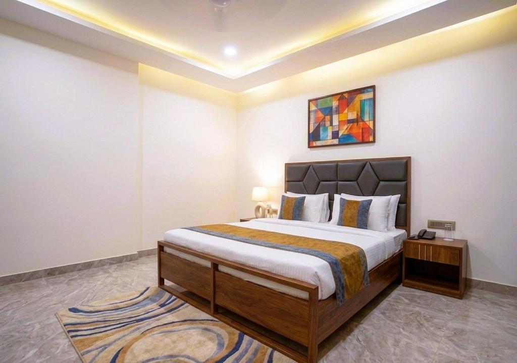 a bedroom with a large bed in a room at Hotel Nexus Cyber Hub Near Rapid Metro & Ambience Mall in Gurgaon