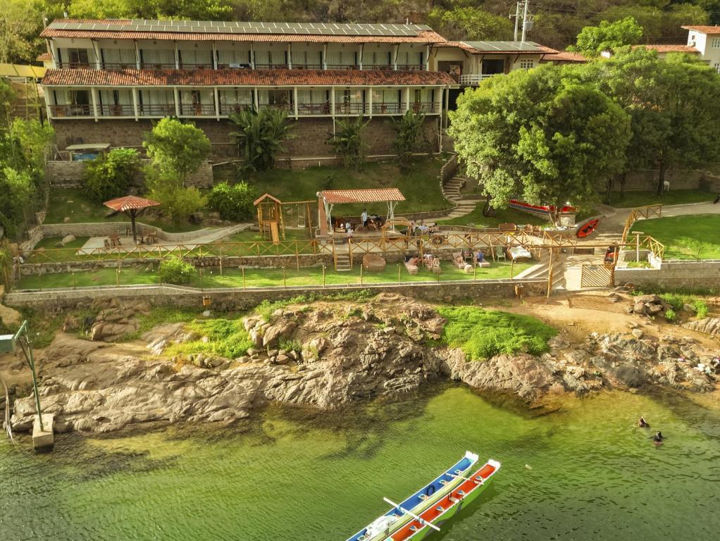 an aerial view of a resort with boats in the water at Pousada Porto de Piranhas in Piranhas