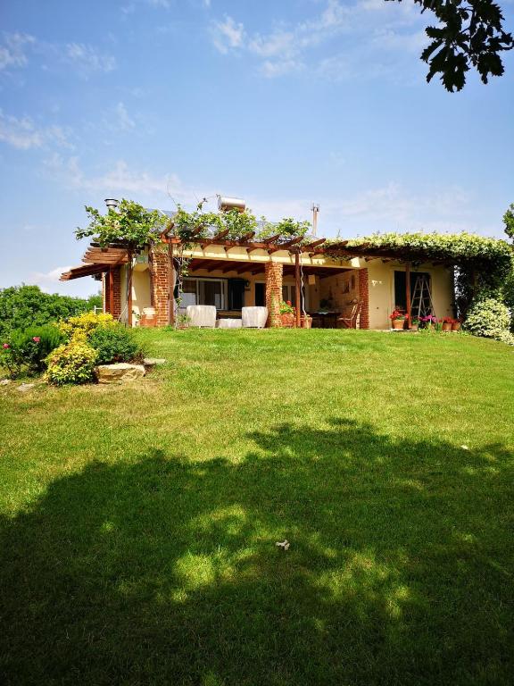 a house with a green lawn in front of it at Villa Trifylli in Mesimvría
