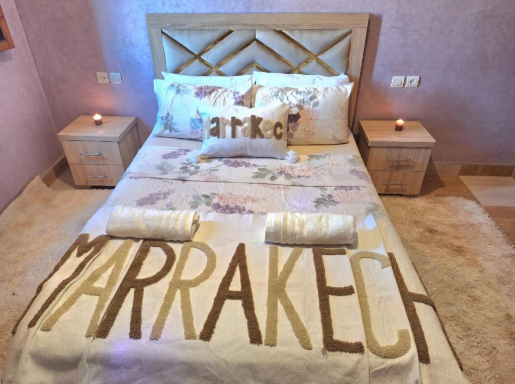 a large bed in a bedroom with two night stands at Oasis Menara in Marrakesh