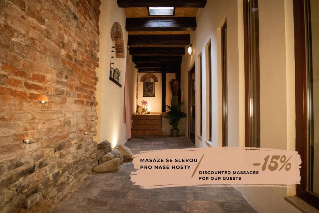 a hallway with a sign that readsmusic and arrow no was rusty at Orient Spa in České Budějovice