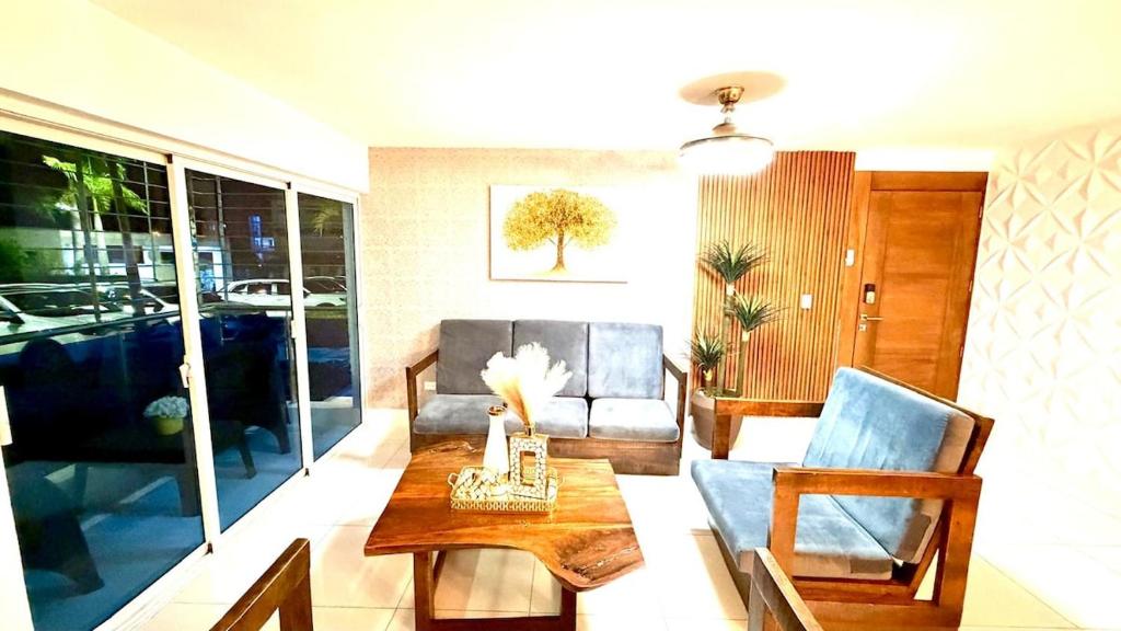 a living room with a couch and a table at Modern Accommodation Monumental Area Royal Tower 6 in Santiago de los Caballeros