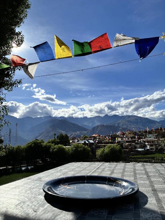 a plate on a table with a view of a city at Moon Lake Hotel, Nako in Nako