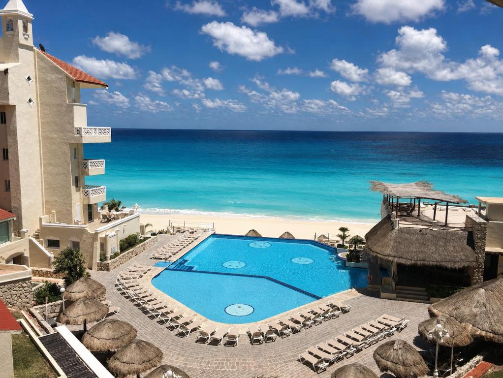 ein Resort mit Swimmingpool direkt am Strand in der Unterkunft Suites Sol y Luna in Cancún