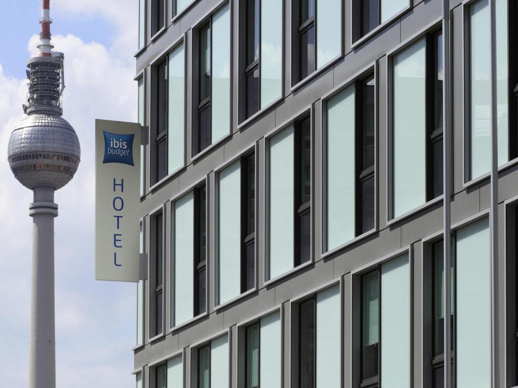a building with the tv tower in the background at ibis budget Berlin Alexanderplatz in Berlin