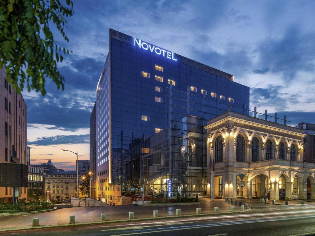 a building with a sign on the top of it at Novotel Bucharest City Centre in Bucharest