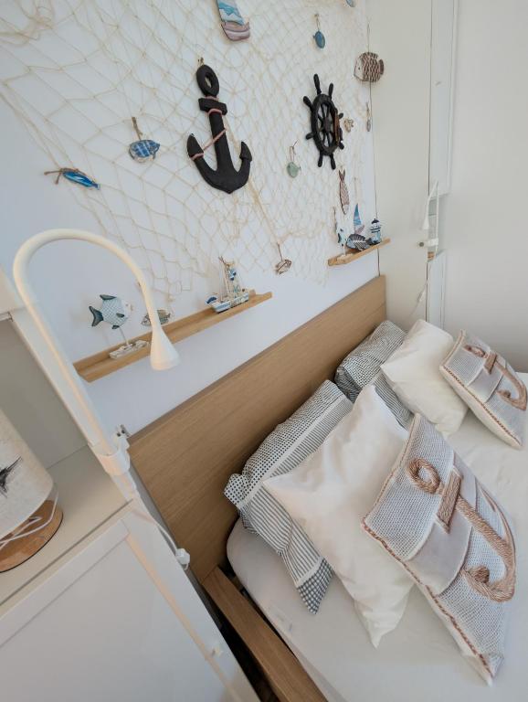 a bedroom with a bed with a sink and pillows at Balatonfenyvesparti kisház in Balatonfenyves