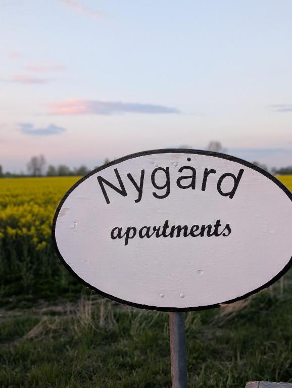 a sign in front of a field of flowers at Nygård Apartments in Klagstorp