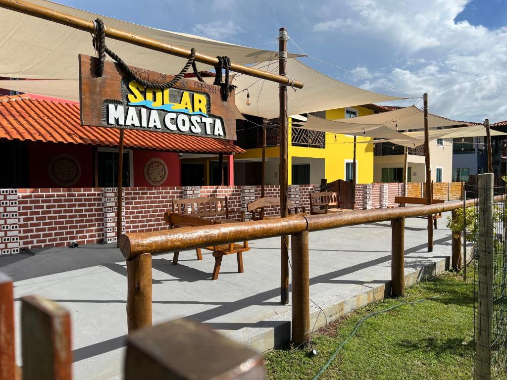 a restaurant with a sign that reads sun malaza costachi at Pousada Solar Maia Costa in Atins