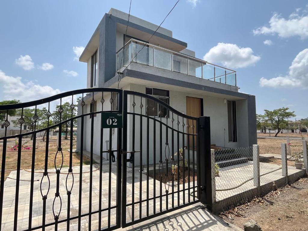 a house with a gate in front of it at Auravista in Pālghar