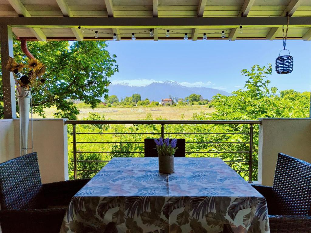 a table on a balcony with a view of a field at Zoe By The Sea in Paralia Katerinis