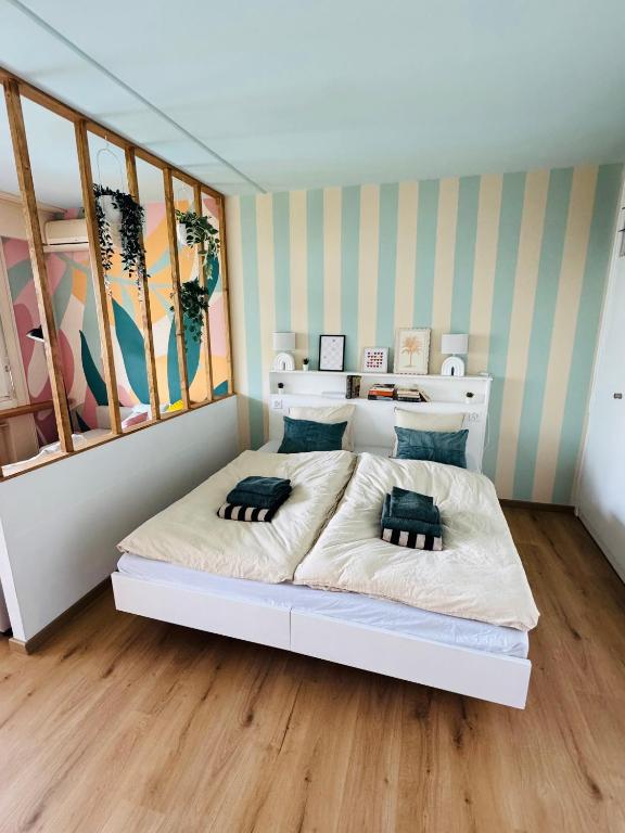a bedroom with a large white bed in a room at Ticino Lakeview Apartment in Bissone