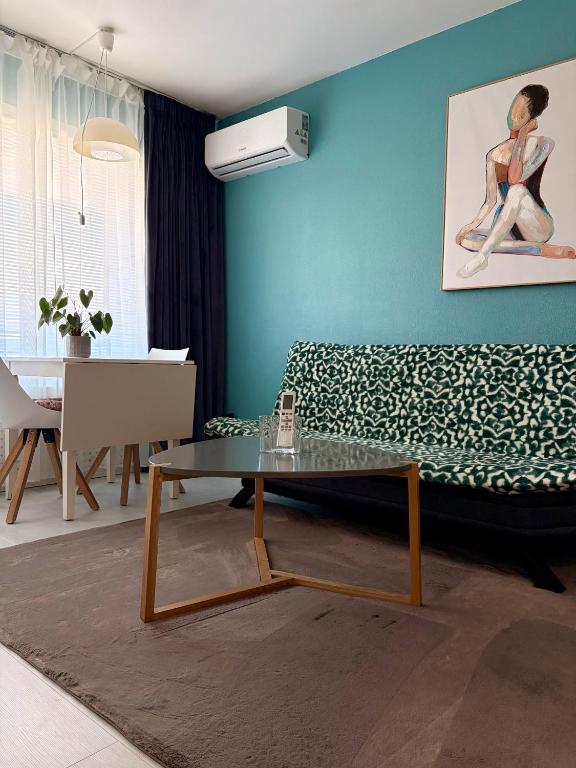 a living room with a couch and a table at Central Studio Apartment in Pori