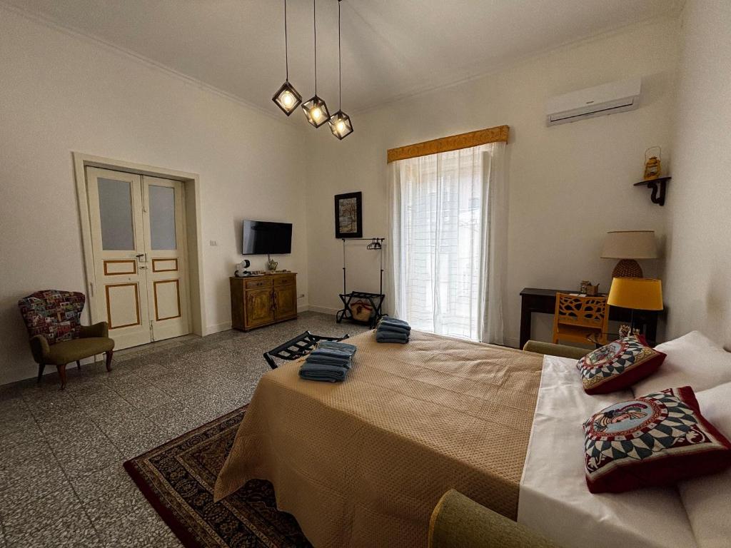 a bedroom with a large bed and a window at Etna Docet in Nicolosi