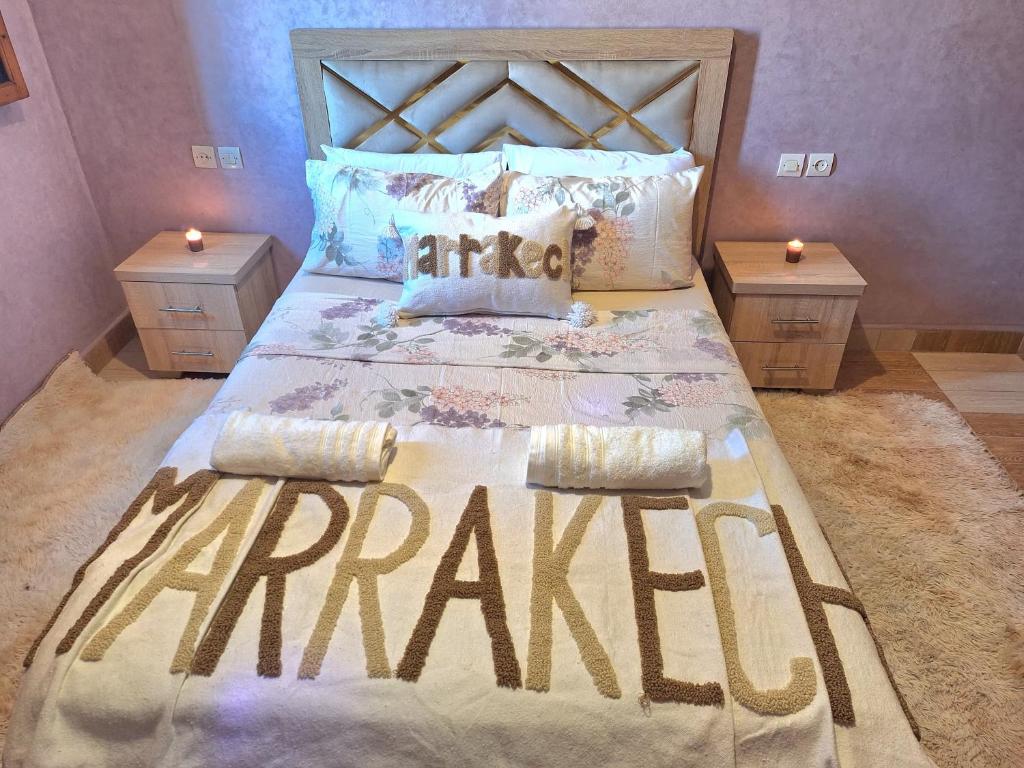 a large bed in a bedroom with two night stands at Oasis Menara in Marrakesh