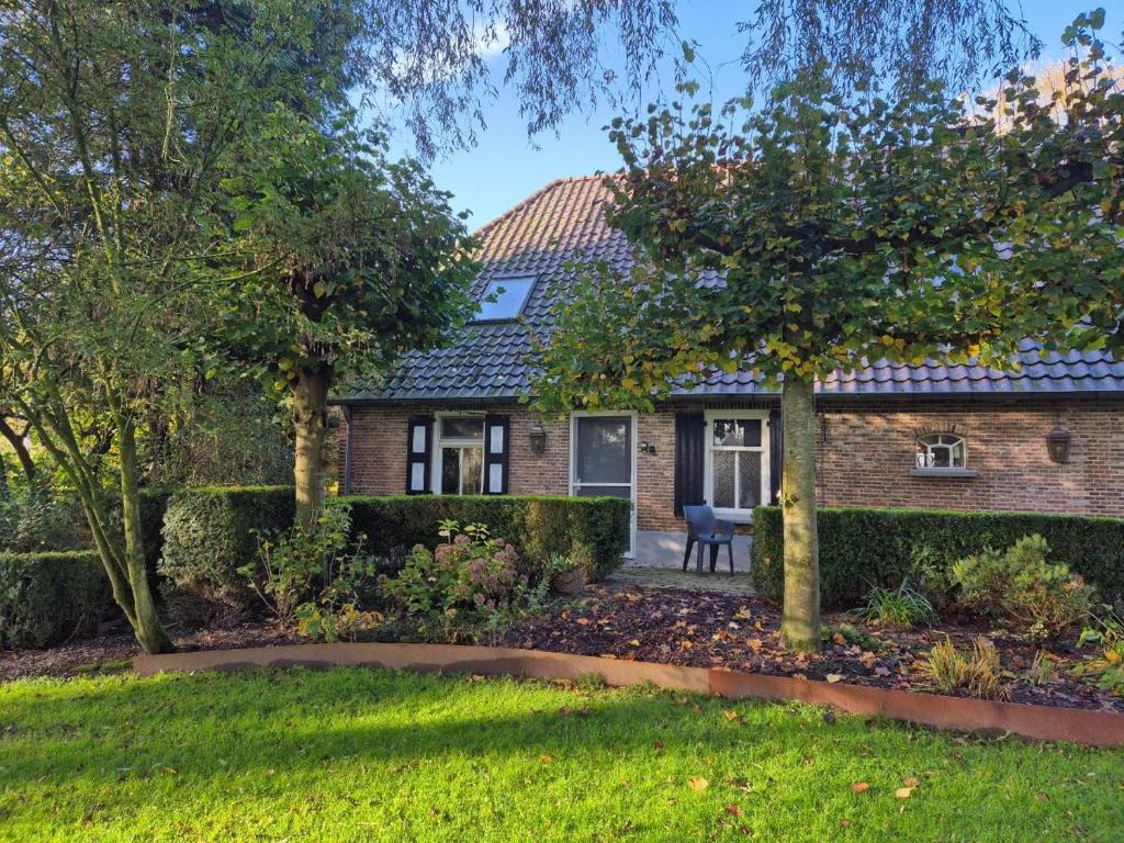 a brick house with a garden in front of it at De Grote Belt in Oene