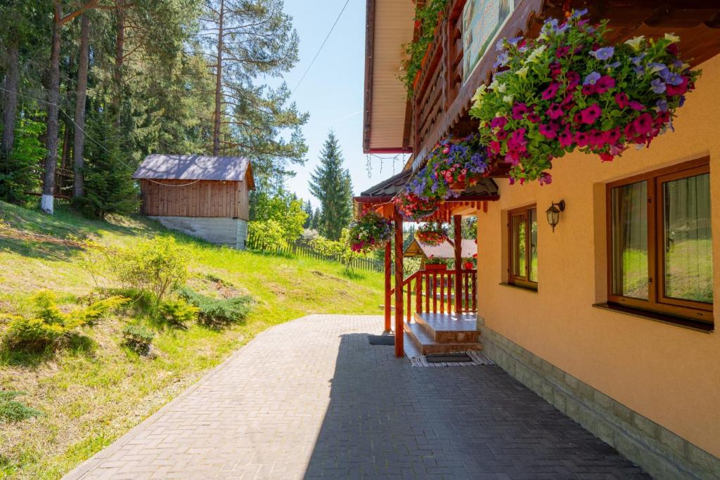 a building with flowers hanging on the side of it at Casa Ursuleasa in Ciumîrna