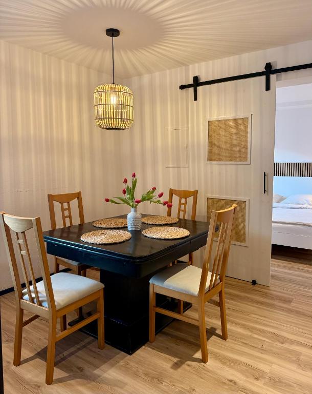 a dining room with a black table and chairs at Ferienwohnung Natters - Your vacation base in Innsbruck
