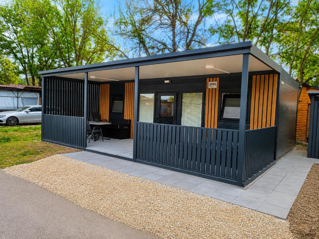 a small house with a black exterior at Hiška Gaia- pool tickets included in Brežice