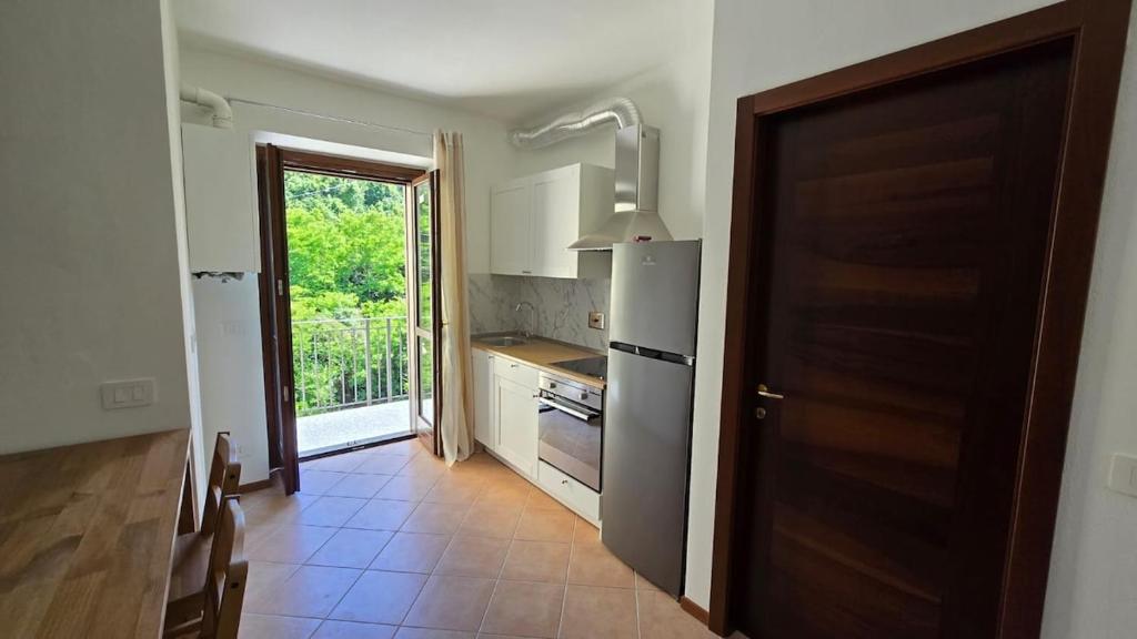 a kitchen with a refrigerator and a stove top oven at Fuga in Valpolcevera Comfort e Relax in Mignanego