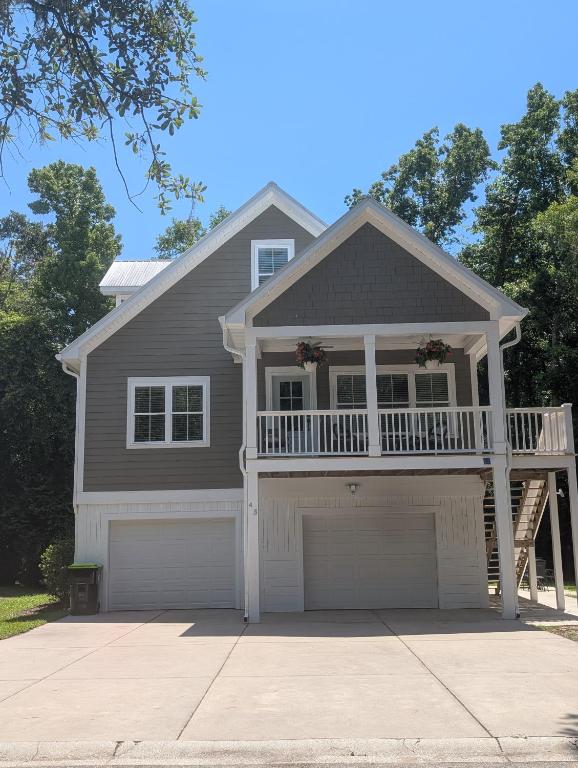 a house with a balcony and a garage at Sandnapper in Pawleys Island