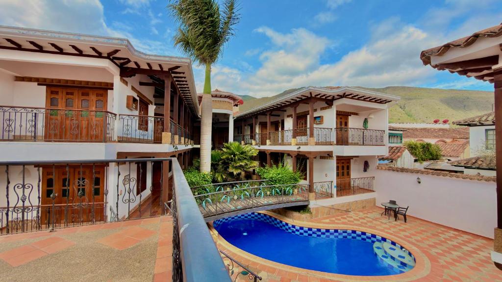 an exterior view of a house with a swimming pool at Hotel Boutique Villa Roma in Villa de Leyva