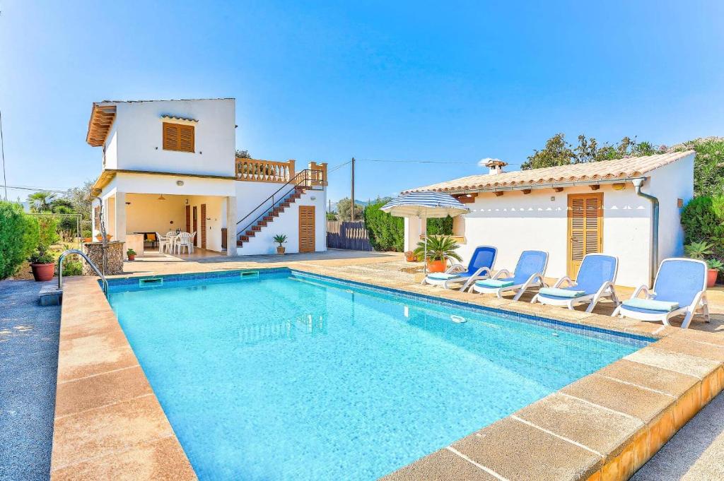 a villa with a swimming pool in front of a house at Villa Oliver by Villa Plus in El Port