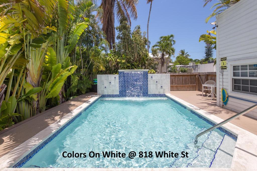 a swimming pool in the backyard of a house at Colors on White in Key West