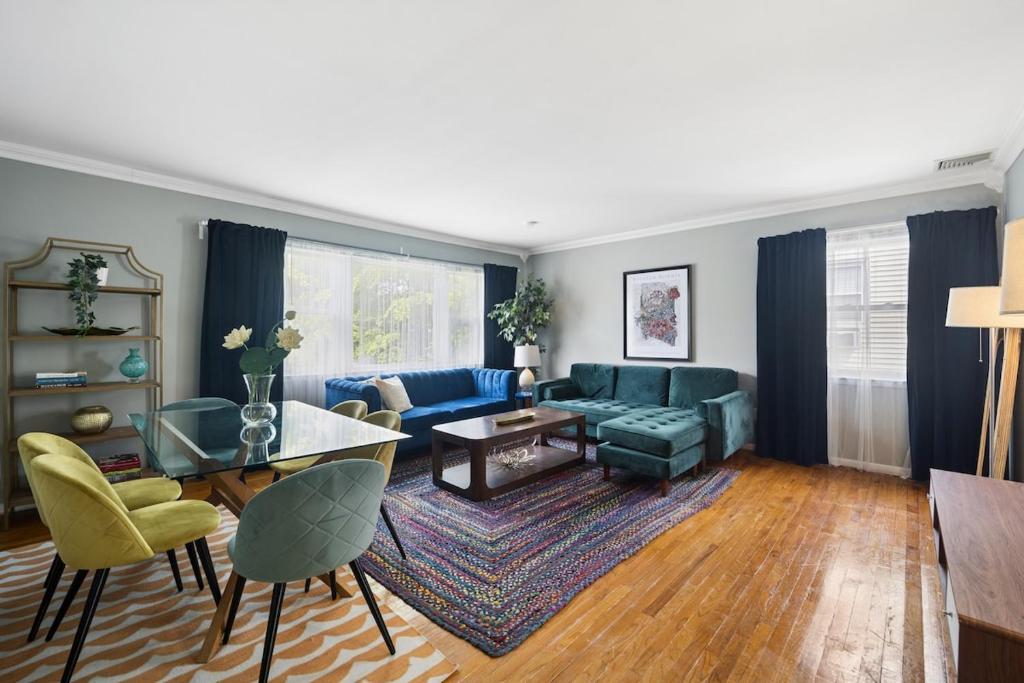 a living room with a blue couch and a table at Retro 3BR Walkup Apt and Shared Yard and Parking in Yonkers