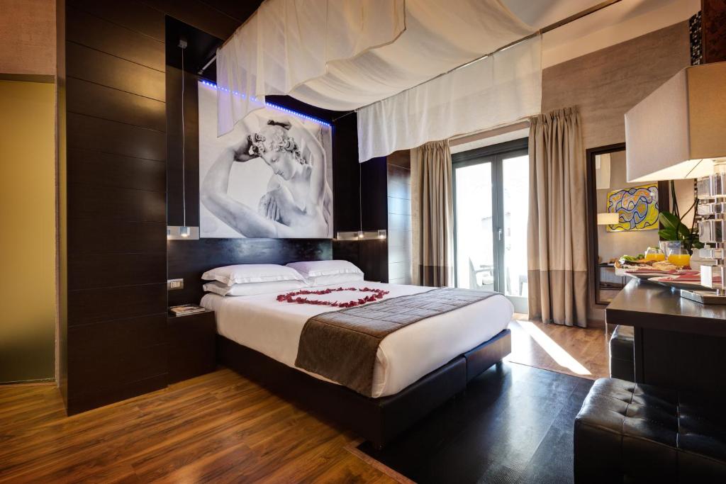 A bed or beds in a room at Dharma Luxury Hotel