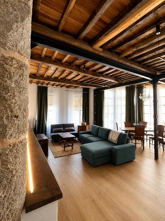 a living room with a couch and a table at Casa Plaza do Millo in Celanova