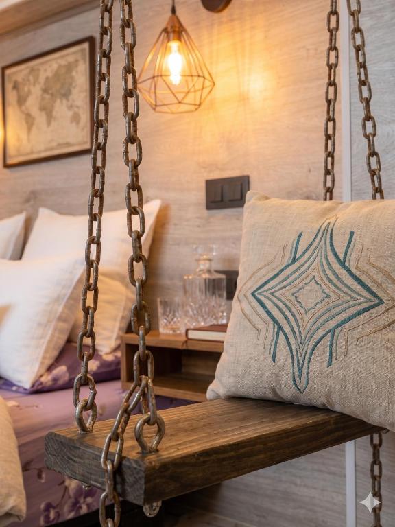 a swing in a room with a bed and a pillow at City Mini Hotel in Chişinău