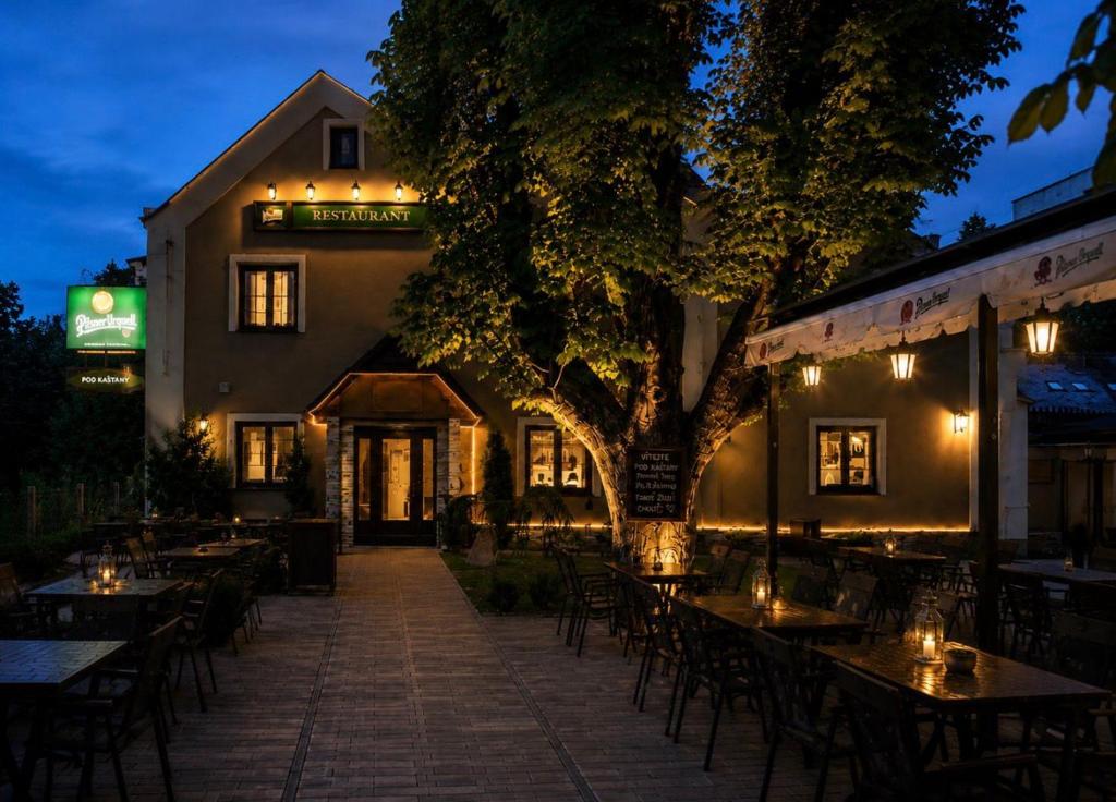 a restaurant with tables and chairs in front of a building at Hotel & Restaurant Pod Kaštany in Krupka