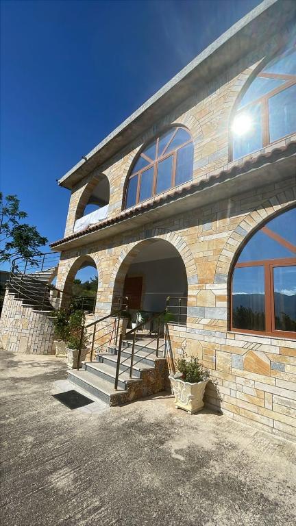 a large stone building with a large window at Mateo Apartaments in Vlorë