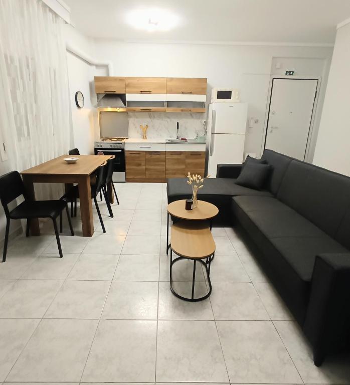 a living room with a couch and a table at Elenis Garden View Apartment in Perea
