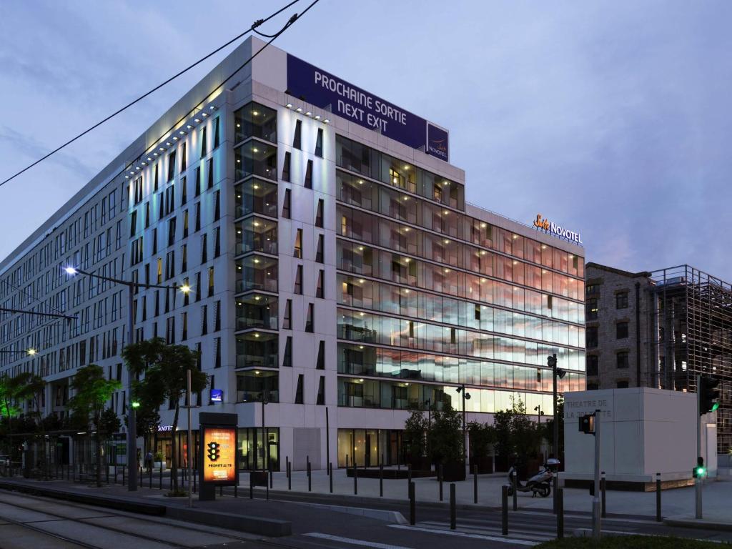 a large building with a sign on the side of it at Novotel Suites Marseille Centre Euromed in Marseille