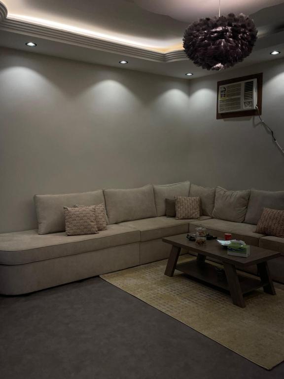 a living room with a couch and a coffee table at غرفه وصاله in Tabuk