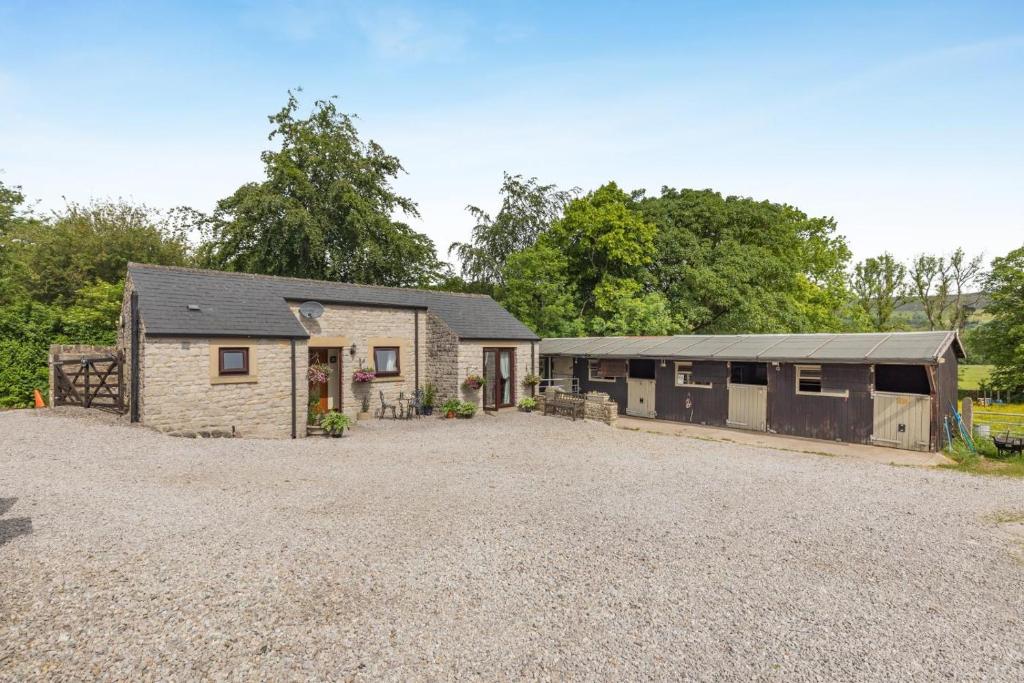 a home with a barn with a gravel driveway at 1 Bed in Hope Valley oc-pk849 in Bradwell