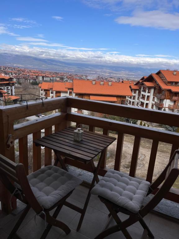 a table and chairs on a balcony with a view at Mirabell Studio Bansko - Amazing view & fireplace in Bansko