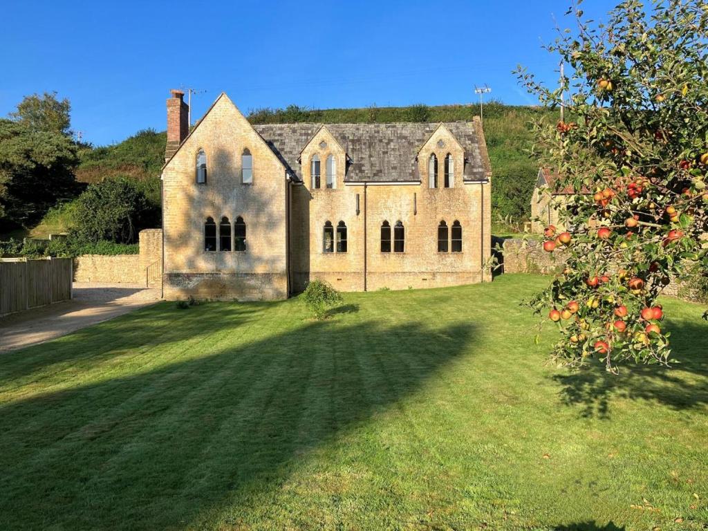 an old stone house on a grassy field at 4 Bed in Bridport oc-58847 in Powerstock