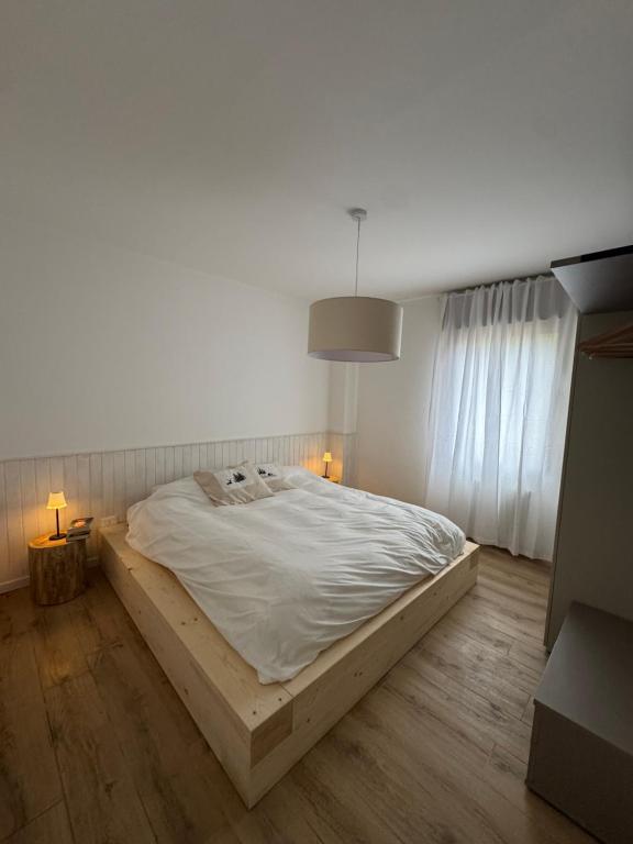 a bedroom with a large bed in a room with wooden floors at Appartamento alla Lupa in Vetriola