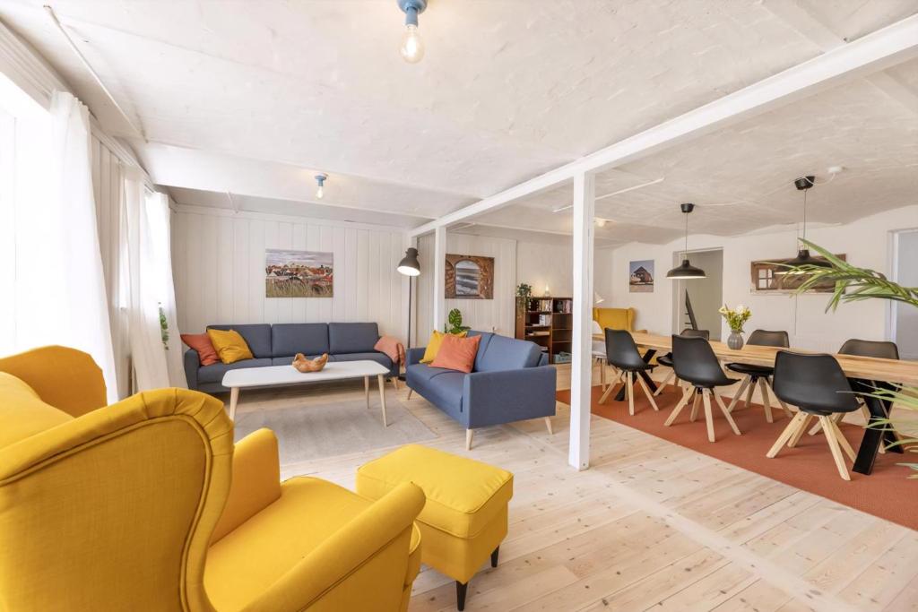 a living room with a couch and chairs and a table at Kostalden A Cozy Setting For Family Time in Hjørring