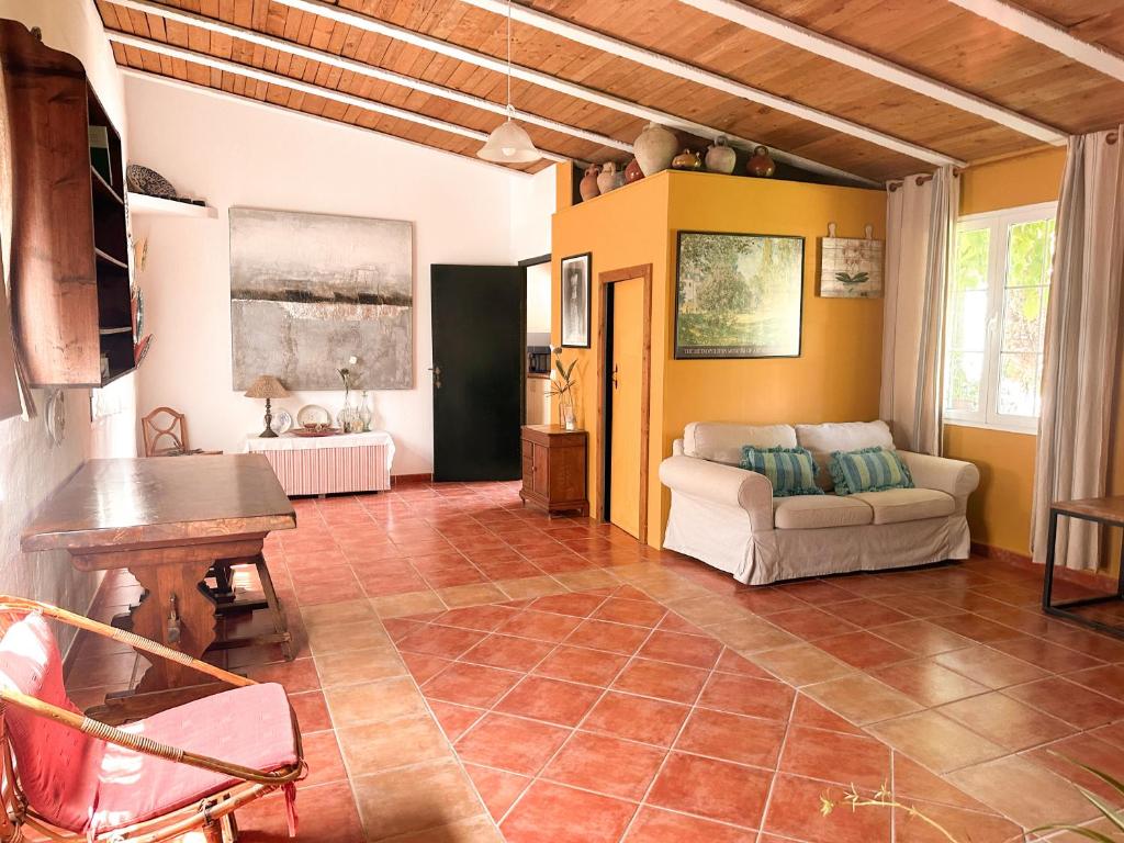 a living room with a couch and a table at Casa Olivia Sant Lluis in Sant Lluis