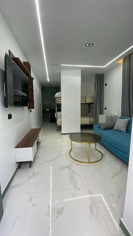 a living room with a bed and a table at Luxury king studio in 6th Of October