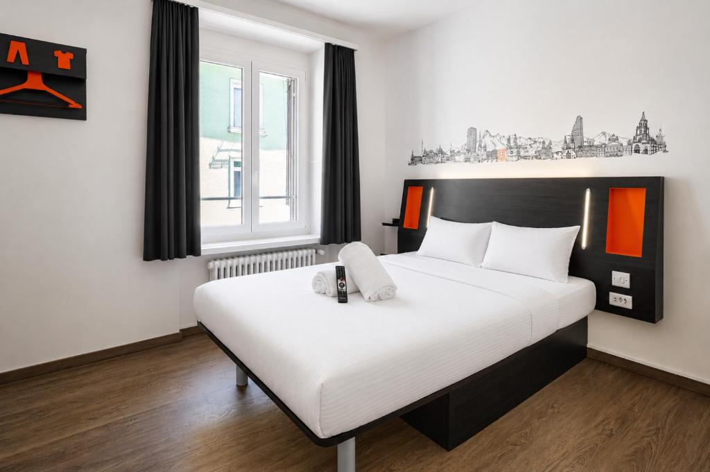 a bedroom with a large white bed in a room at easyHotel Zürich City Limmatplatz in Zurich