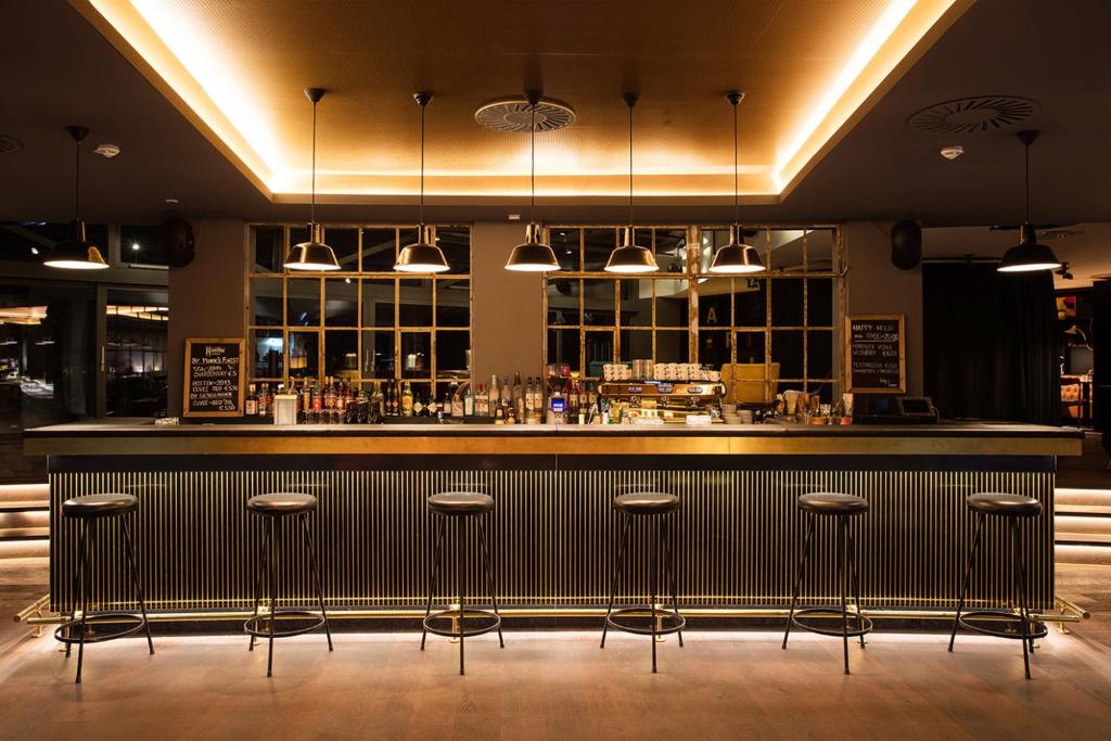 a bar with bar stools in a restaurant at Ruby Marie Hotel Vienna by IHG in Vienna