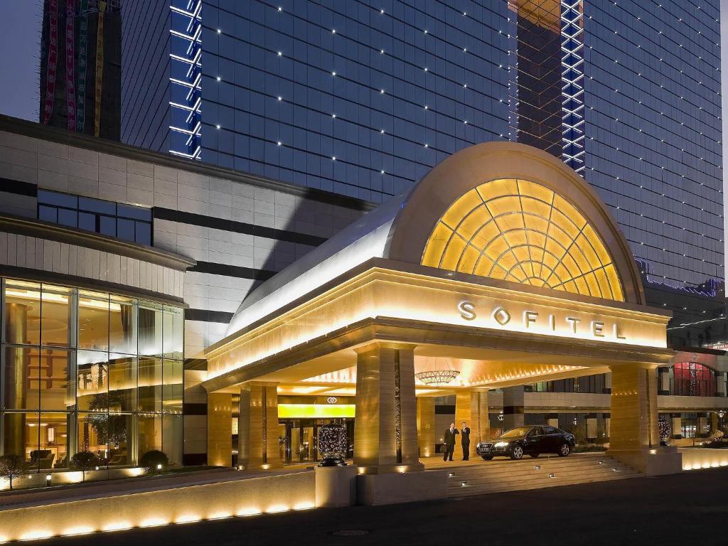 a large building with a sign in front of it at Sofitel Harbin in Harbin