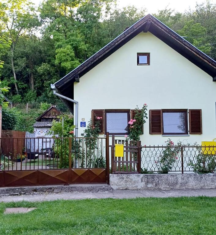 a white house with a gate and a fence at Sunstation in Šarengrad